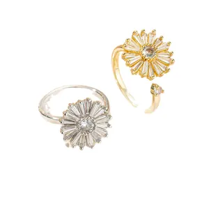 Elegant rotating chrysanthemum rings with zircon micro-setting in gold and silver finish.