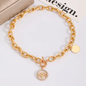 Dettaglio collana a catena oro vintage con ciondolo albero della vita in cristallo e chiusura OT