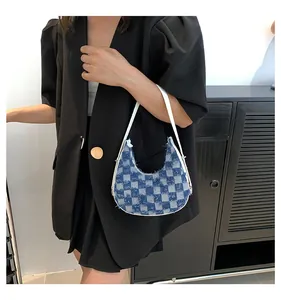 Model carrying a blue checkered denim crescent hobo bag for trendy summer style