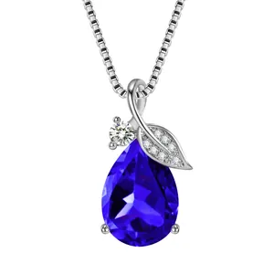 Close-up of elegant pear-shaped blue gemstone necklace with detailed leaf design elements.