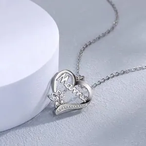 Close-up of silver heart pendant with butterfly and Mama engraving for Mother's Day.