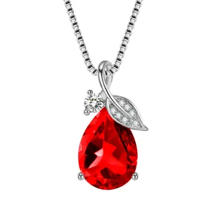 Detailed view of teardrop red stone pendant necklace with elegant sparkling leaf design