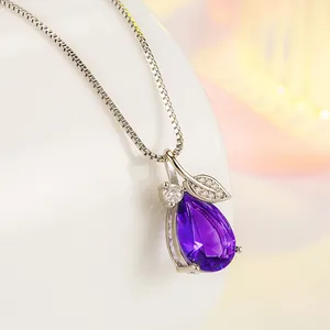 Macro detail of elegant purple teardrop pendant necklace featuring crystal leaf design in silver