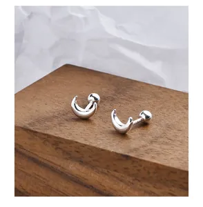 Detailed view of minimalist 999 silver crescent moon screw-back stud earrings