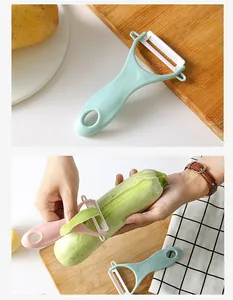 Detail of ceramic vegetable peeler being used to peel a fresh green zucchini