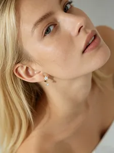 Gros plan de boucles d'oreilles en argent S925 fleur de prunier avec zircons sur mannequin