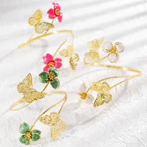 Elegant adjustable floral and butterfly arm cuffs in pink, green, and white enamel colors
