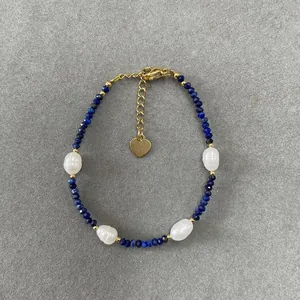 Detail view of blue stone beads and white pearls on a gold-toned beaded bracelet