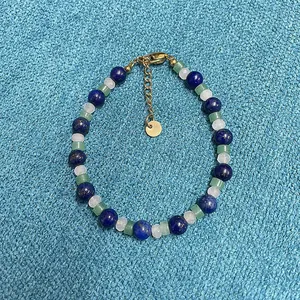 Macro detail of a New Chinese style beaded bracelet with lapis lazuli and jade stones