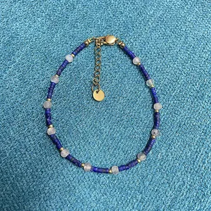 Close-up of blue lapis lazuli beaded bracelet with gold accents and translucent stones