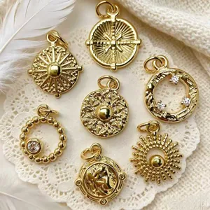 Detail shot of vintage gold-plated sun pendants with zircon accents for DIY jewelry