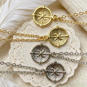 Detailed macro view of vintage gold and silver sunburst star pendants on white lace