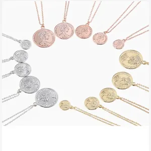 Close-up of retro coin necklaces featuring queen portrait in gold, rose gold and silver