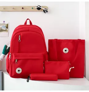 Detailed view of the red four-piece student backpack set including tote and pencil case.