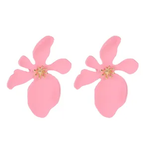 Close-up of pink matte lacquer flower earrings with textured gold stamen detail.