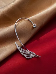 Detailed macro shot of minimalist silver leaf ear cuff with a sparkling zircon stone