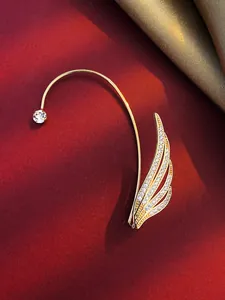 Detail of gold-plated wing ear cuff with sparkling cubic zirconia stones for non-pierced ears.