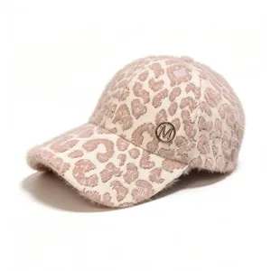 Close-up view of a leopard print plush baseball cap featuring a metallic M badge.