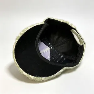 Interior detail showing the black lining and structure of the plush leopard print cap.