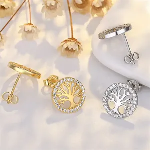 Macro view of sterling silver Tree of Life stud earrings featuring sparkling crystals