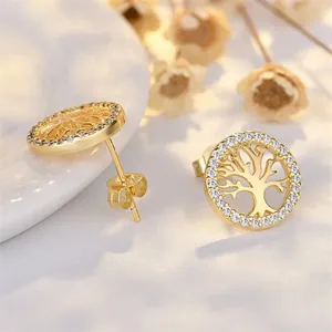 Detailed view of Tree of Life stud earrings with sparkling CZ stones and gold finish