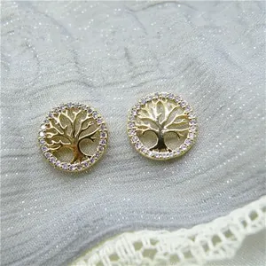 Close-up detail of golden Life Tree stud earrings featuring a sparkling zirconia halo