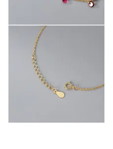 Close-up of gold clasp and extender chain on S925 silver bracelet with red crystals