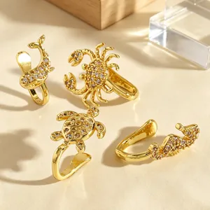 Detailed view of gold ocean animal nose clips with sparkling zircon stones