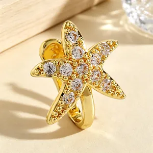 Macro view of gold-colored starfish nose clip with shimmering cubic zirconia