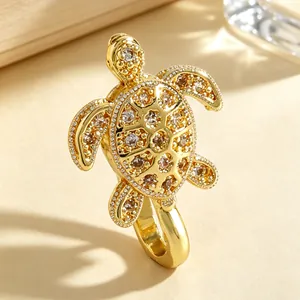 Detailed macro shot of a golden turtle non-piercing nose clip with sparkling zircons.