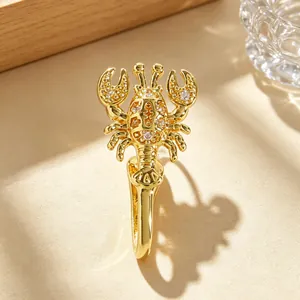 Detailed macro view of a gold lobster nose clip inlaid with sparkling zircons