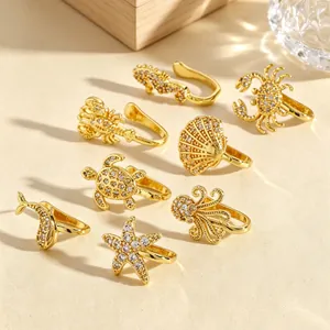 Detailed macro view of eight unique sea animal themed gold non-piercing nose cuffs with zircons
