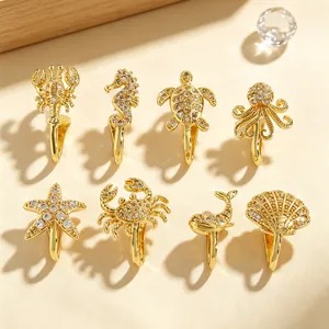 Group of assorted ocean-themed gold-plated nose clips with sparkling zircon details.