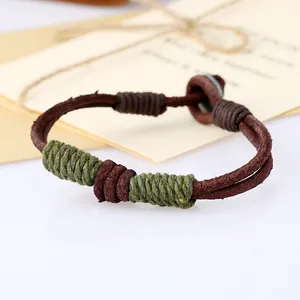 Macro view of handmade braided leather bracelet with green cotton thread accents