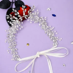 Elegant crystal bridal headband with pearls and white ribbon on purple background