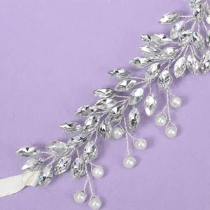 Silver bridal wedding hairband with marquise crystals and white pearls on purple background