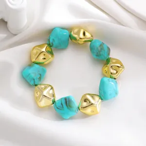 Detail view of retro irregular turquoise marbled and gold-colored CCB beads