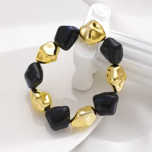 Close-up of retro irregular CCB bead bracelet with black marble and gold beads