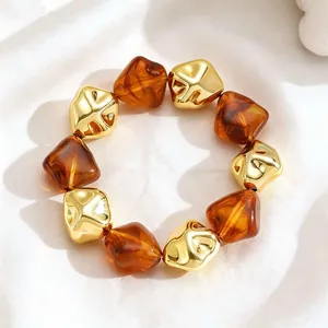 Detail showing the textured amber resin and golden beads of this elegant retro bracelet