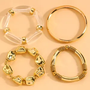 Detailed view of a four-piece fashion gold and clear bead bracelet set for women