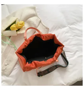 Large capacity orange quilted nylon tote bag interior with bohemian patterned shoulder strap