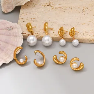 Close-up of elegant gold plated stainless steel pearl earrings on decorative props.