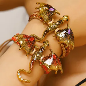 Close-up detail of vintage enamel dragon bracelet with colorful crystals and woven strap.