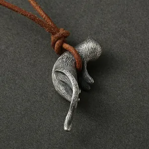 Macro view of a detailed 925 sterling silver cat pendant on a brown cord necklace