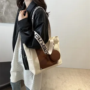 Large capacity canvas tote bag with contrast leather pocket and patterned strap