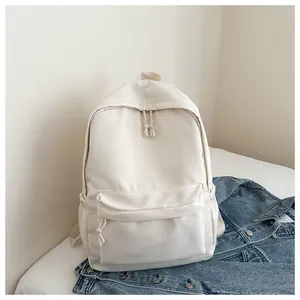 Front view of minimalist white Japanese style backpack on denim jacket