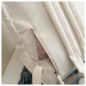 Close-up view of the hidden back zipper pocket on a white minimalist girl's backpack