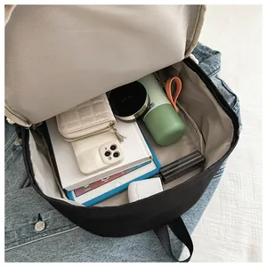 Detailed view showing the spacious main compartment of a black casual travel backpack