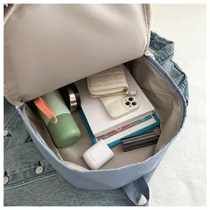 Interior view of the light blue backpack showing large capacity for daily essentials