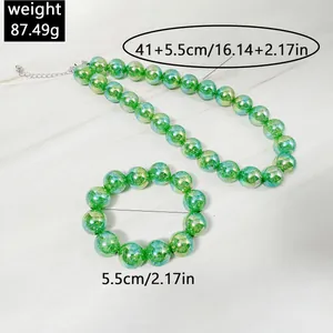 Close-up of vibrant green acrylic beaded necklace and matching bracelet set with measurement data